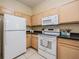 Efficient kitchen with white appliances and ample cabinet space for storage at 20302 Noble Oak Pl, Tampa, FL 33647