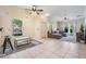 Bright living room featuring tile floors, a ceiling fan, and seamlessly transitions into the kitchen at 20302 Noble Oak Pl, Tampa, FL 33647