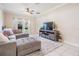 Spacious living room with neutral tones, ceiling fan, tile floors and cozy seating at 20302 Noble Oak Pl, Tampa, FL 33647