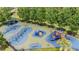 Aerial view of playground with colorful play structures, swings, and a safe, cushioned ground at 20302 Noble Oak Pl, Tampa, FL 33647
