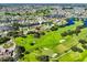 Drone shot displays a charming house nestled beside a picturesque golf course and winding waterways at 2110 W View Dr, Sun City Center, FL 33573