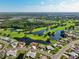An aerial view shows a meticulously kept golf course community with scenic lakes and well-maintained homes at 2110 W View Dr, Sun City Center, FL 33573
