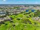 A scenic aerial shows a lush, vibrant golf course community dotted with sparkling lakes and beautiful homes at 2110 W View Dr, Sun City Center, FL 33573
