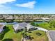 A stunning aerial view of a well-maintained home with lush landscaping and waterfront views at 2110 W View Dr, Sun City Center, FL 33573