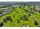 A stunning aerial view showcases a lush green golf course, mature trees and residential areas at 2110 W View Dr, Sun City Center, FL 33573