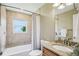 Bathroom features tiled bathtub and granite countertop at 2110 W View Dr, Sun City Center, FL 33573