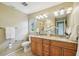 Bathroom featuring double sinks, granite countertops, and a walk-in shower, seamlessly blending luxury with functionality at 2110 W View Dr, Sun City Center, FL 33573