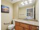 Bathroom vanity with granite counters, a large mirror, and access to laundry room at 2110 W View Dr, Sun City Center, FL 33573