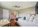 Bedroom with a wood frame bed with white linens and wood flooring and a dresser at 2110 W View Dr, Sun City Center, FL 33573