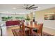 Cozy dining room featuring an area rug, a ceiling fan, and expansive views of the outdoors at 2110 W View Dr, Sun City Center, FL 33573
