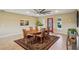 Bright dining room features a decorative rug, a ceiling fan, and space for entertaining guests at 2110 W View Dr, Sun City Center, FL 33573