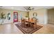 Open dining area featuring a ceiling fan and a large area rug beneath a wooden dining table at 2110 W View Dr, Sun City Center, FL 33573