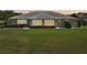 Beautiful home exterior featuring a lush green lawn and manicured landscaping at sunset at 2110 W View Dr, Sun City Center, FL 33573