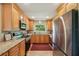 Modern kitchen featuring stainless steel appliances, granite countertops, and wood cabinets at 2110 W View Dr, Sun City Center, FL 33573