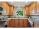 Well-equipped kitchen with wood cabinets, granite countertops, and stainless steel appliances offering both style and convenience at 2110 W View Dr, Sun City Center, FL 33573