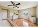 Bright main bedroom features wood floors, a ceiling fan, white furniture and a serene ambiance at 2110 W View Dr, Sun City Center, FL 33573