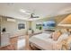 Bright main bedroom with wood floors, ceiling fan, coordinated white furniture and neutral-toned walls at 2110 W View Dr, Sun City Center, FL 33573