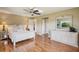 Spacious main bedroom with light walls, wood floors, ceiling fan, and coordinated white furniture and decor at 2110 W View Dr, Sun City Center, FL 33573