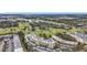 Scenic aerial view of a condo building overlooking a well-maintained golf course with water features and mature trees at 225 Country Club Dr # 1506, Largo, FL 33771