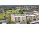 Elevated view of condo building with well-kept grounds, a golf course in the distance, and mature landscaping at 225 Country Club Dr # 1506, Largo, FL 33771