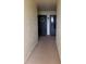Neutral hallway leads to front door with wreath at 225 Country Club Dr # 1506, Largo, FL 33771