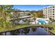 A pool area is fenced and located near mature landscaping, covered parking, and other low-rise condos at 225 Country Club Dr # 1506, Largo, FL 33771