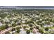 Wide aerial shot displaying the neighborhood surrounded by green trees at 2270 Spruce Ln # B, Palm Harbor, FL 34684
