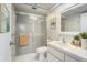 This modern bathroom has a frosted glass shower and a white sink at 2270 Spruce Ln # B, Palm Harbor, FL 34684