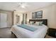 This staged bedroom is freshly painted and features an ensuite bathroom at 2270 Spruce Ln # B, Palm Harbor, FL 34684