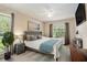 This staged bedroom has two large windows, a ceiling fan and neutral tones at 2270 Spruce Ln # B, Palm Harbor, FL 34684