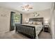 This staged bedroom features a large window for natural light and a decorative ceiling fan at 2270 Spruce Ln # B, Palm Harbor, FL 34684