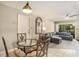 Cozy dining area featuring a glass table, chairs, and a view into the adjoining living room at 2270 Spruce Ln # B, Palm Harbor, FL 34684