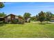 Charming single-story home with a well-manicured lawn and mature trees on a beautiful sunny day at 2270 Spruce Ln # B, Palm Harbor, FL 34684