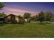 Charming single-story home with a well-manicured lawn and mature trees under a gorgeous twilight sky at 2270 Spruce Ln # B, Palm Harbor, FL 34684