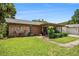 Well-maintained single-story home with lush front lawn and mature trees at 2270 Spruce Ln # B, Palm Harbor, FL 34684