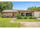 Charming single-story home with a brick facade, well-manicured lawn, and lush landscaping at 2270 Spruce Ln # B, Palm Harbor, FL 34684