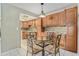 Charming eat-in kitchen featuring rich wood cabinetry, granite countertops and a decorative backsplash at 2270 Spruce Ln # B, Palm Harbor, FL 34684