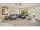 Comfortable living room featuring neutral carpeting, a plush sofa, and sliding door access to the porch at 2270 Spruce Ln # B, Palm Harbor, FL 34684