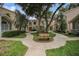 Charming condo complex with mature trees and inviting walkways in a well-maintained community at 2377 Hounds Trl, Palm Harbor, FL 34683