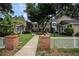 Inviting condo community entrance with brick accents and lush landscaping for a welcoming feel at 2377 Hounds Trl, Palm Harbor, FL 34683