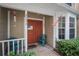 Inviting front entrance with dual doors and a shaded porch area with seating at 2377 Hounds Trl, Palm Harbor, FL 34683