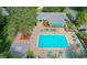 Aerial view of a sparkling community pool with ample seating and well-maintained landscaping at 2377 Hounds Trl, Palm Harbor, FL 34683
