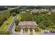 Aerial view of townhomes featuring well-maintained landscaping, garages, and street parking at 26835 Juniper Bay Dr, Wesley Chapel, FL 33544