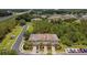 Aerial view of the townhomes showcasing the community, landscaping, and nearby lake and highway at 26835 Juniper Bay Dr, Wesley Chapel, FL 33544