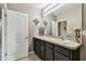 Bathroom featuring a double sink vanity with modern fixtures, mirror, and neutral color scheme at 26835 Juniper Bay Dr, Wesley Chapel, FL 33544