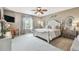 Comfortable bedroom featuring a bed, dresser, and large windows, creating a relaxing space at 26835 Juniper Bay Dr, Wesley Chapel, FL 33544