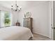 Comfortable bedroom with a wooden armoire, large window, and soft lighting, perfect for relaxation at 26835 Juniper Bay Dr, Wesley Chapel, FL 33544