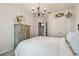 Inviting bedroom with chandelier, and a wooden armoire, creating a relaxing and stylish retreat at 26835 Juniper Bay Dr, Wesley Chapel, FL 33544