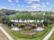 The Seven Oaks entrance features brick pillars, fountains, lush trees and landscaping, and a beautiful lake view at 26835 Juniper Bay Dr, Wesley Chapel, FL 33544