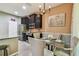 Bright dining area features dark cabinets, stainless appliances, and stylish pendant lighting at 26835 Juniper Bay Dr, Wesley Chapel, FL 33544